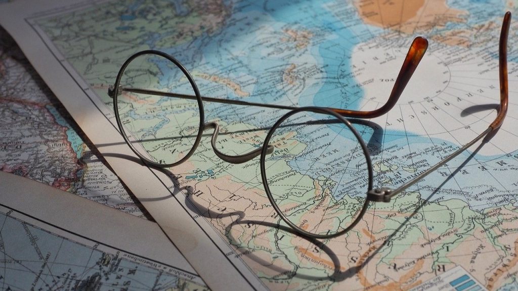 Round eyeglasses left on some world maps